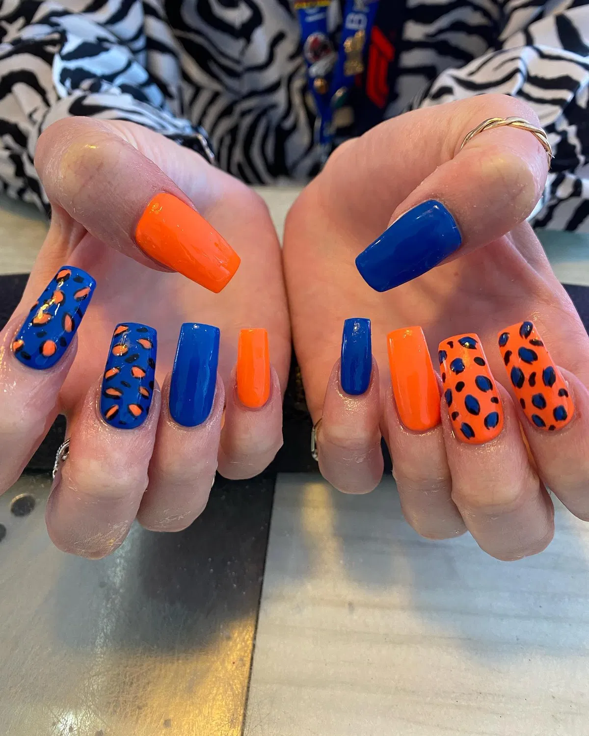Alternating orange/blue solids with mixed leopard-spot accents