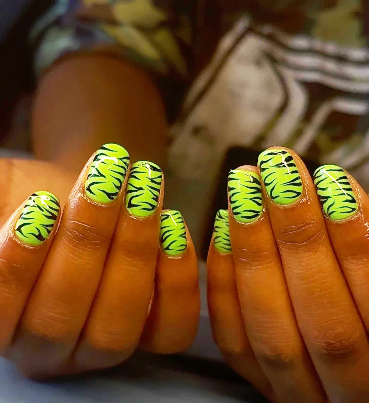 Lime green nails with black wavy stripes