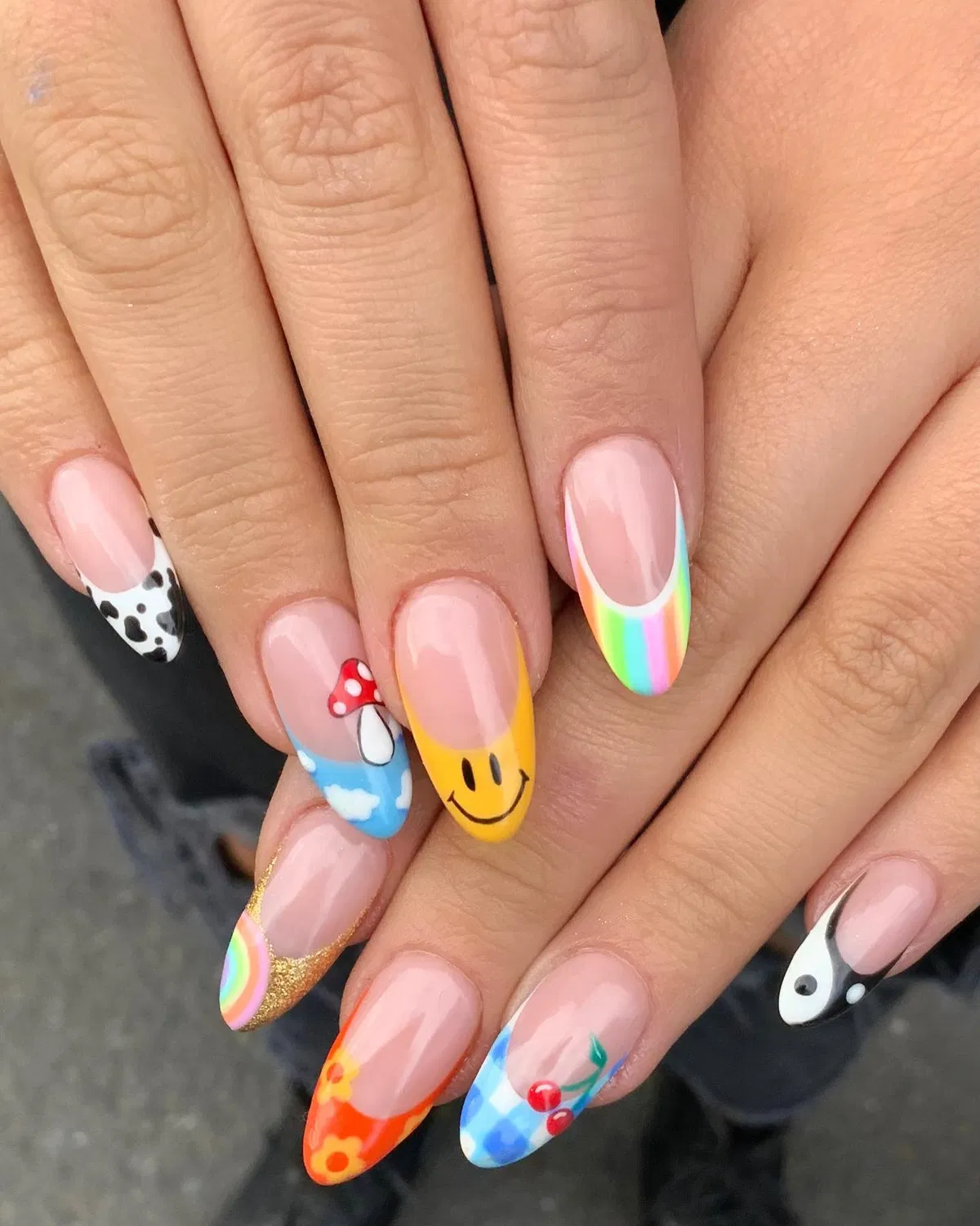 Nude base with mixed tips: smiley, rainbow, clouds, and icons