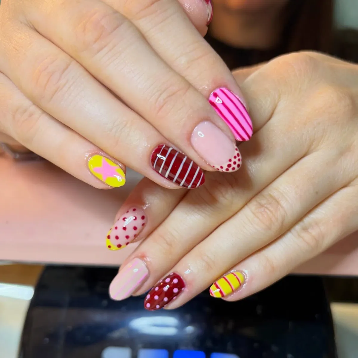 Pink-and-red pattern clash: stripes, grids, and polka dots