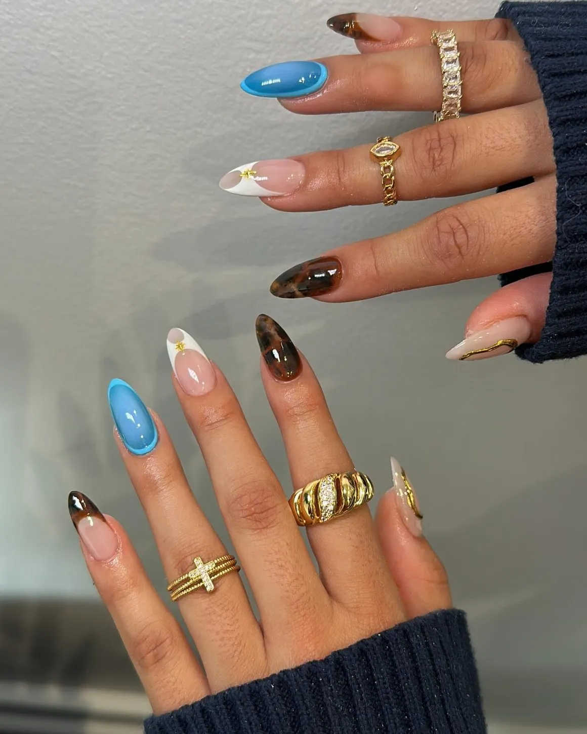 Blue solids, angled white tips, and dark marbled accents