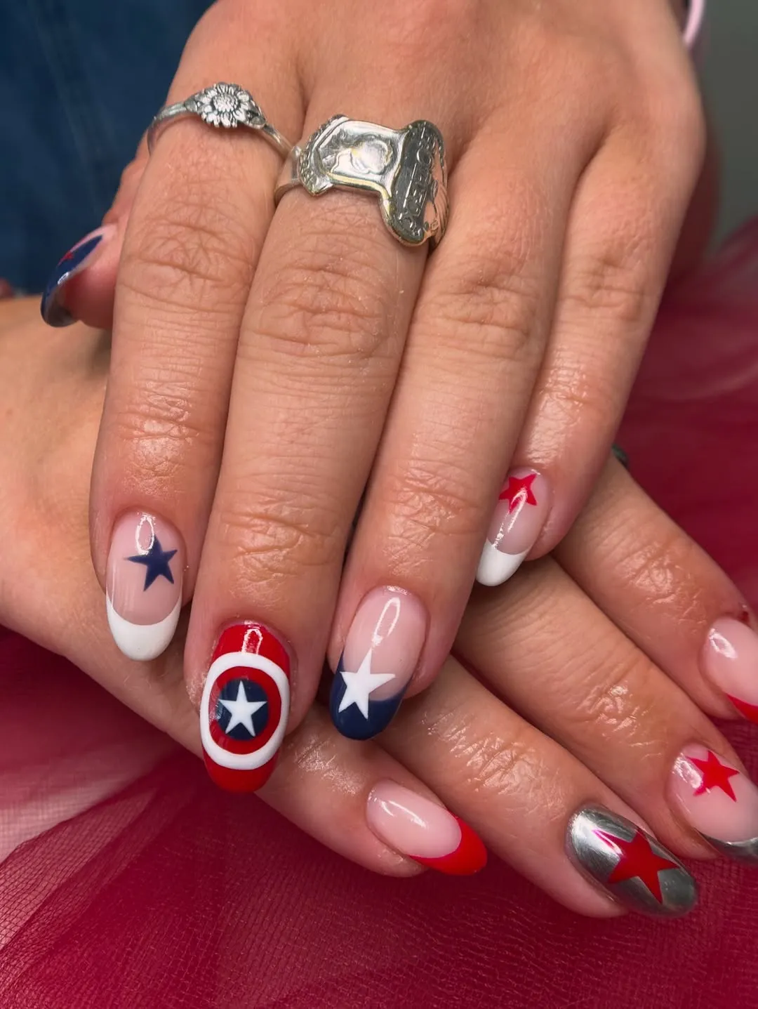 French tips with star motifs and a circular emblem accent