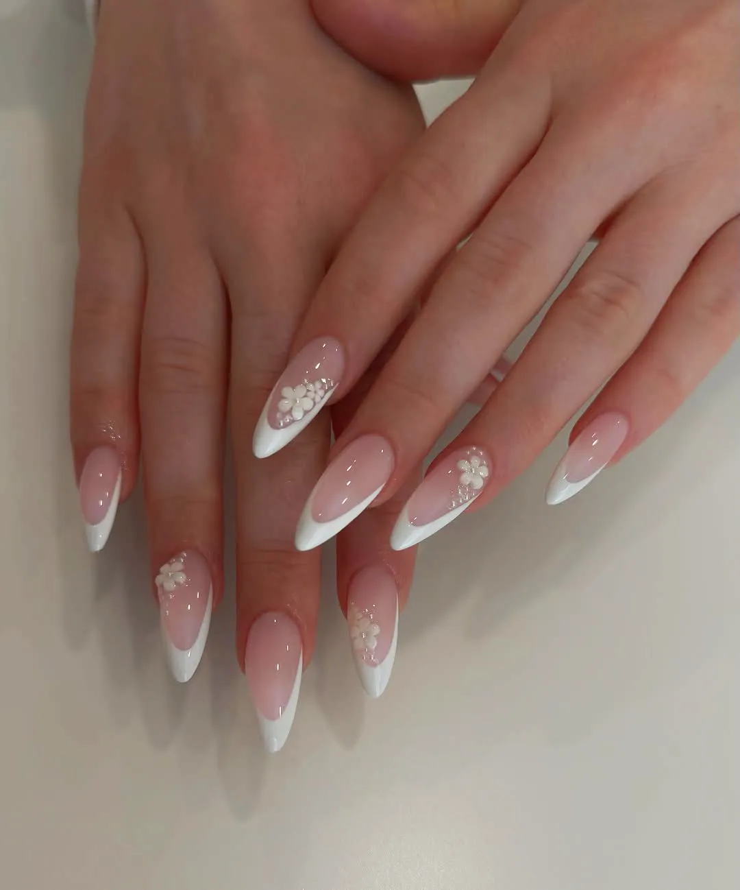 French tips with side-placed 3D flowers and rhinestones