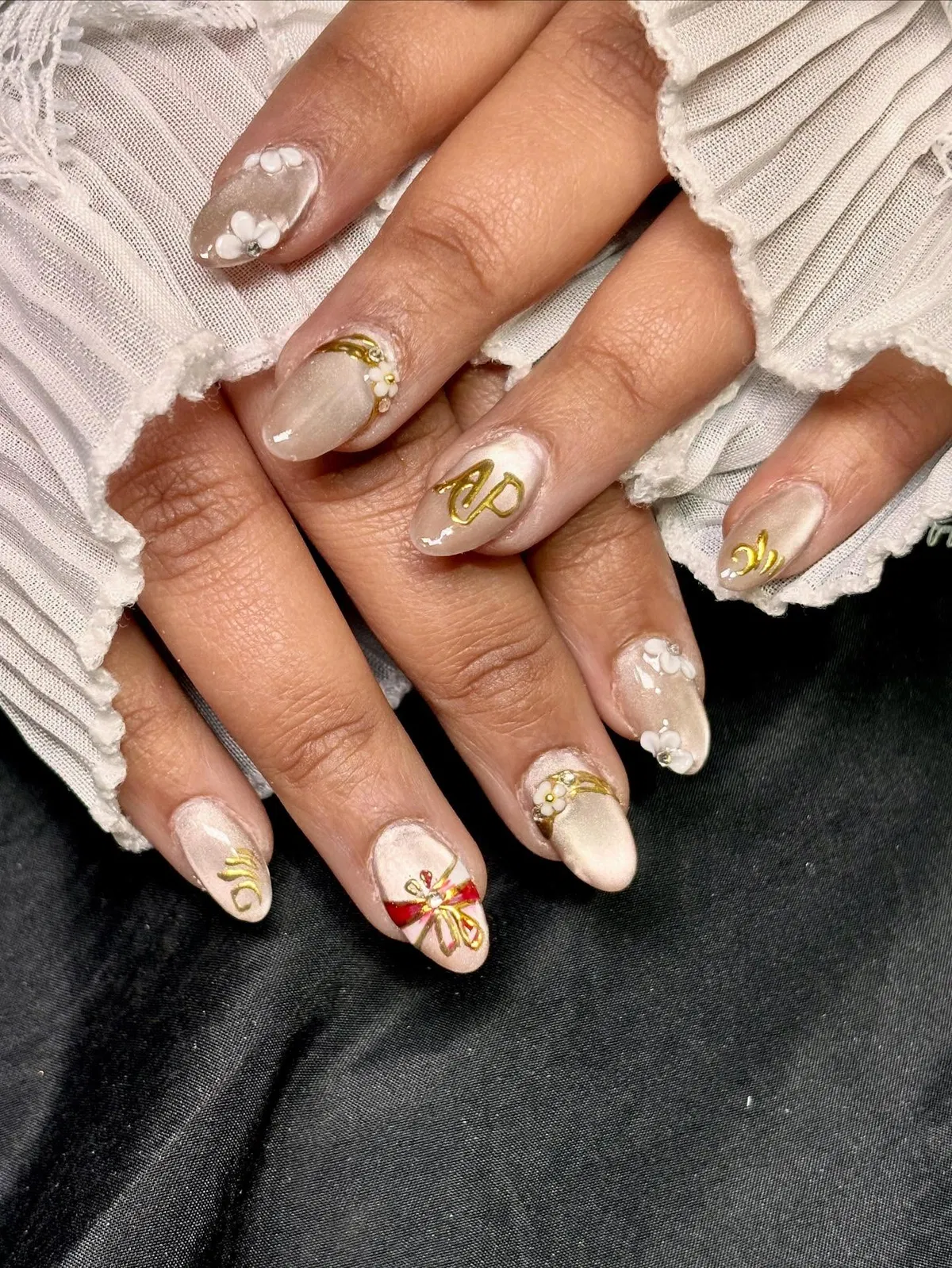 Champagne shimmer with gold swirls and small floral accents