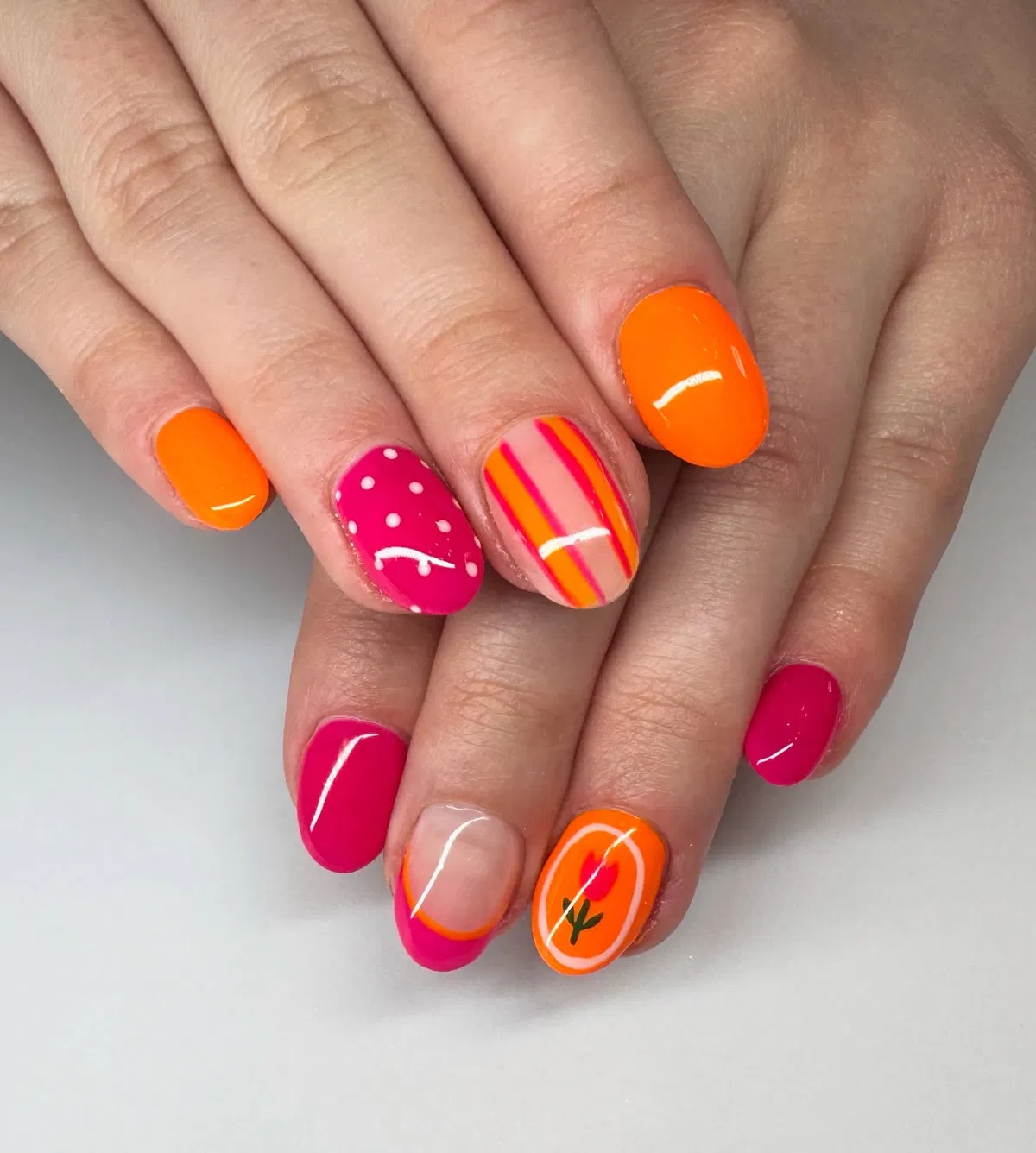 Orange and hot-pink mix with stripes, dots, and a small floral accent
