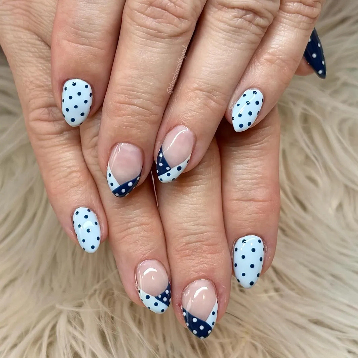 Diagonal French tips with navy polka dots on white