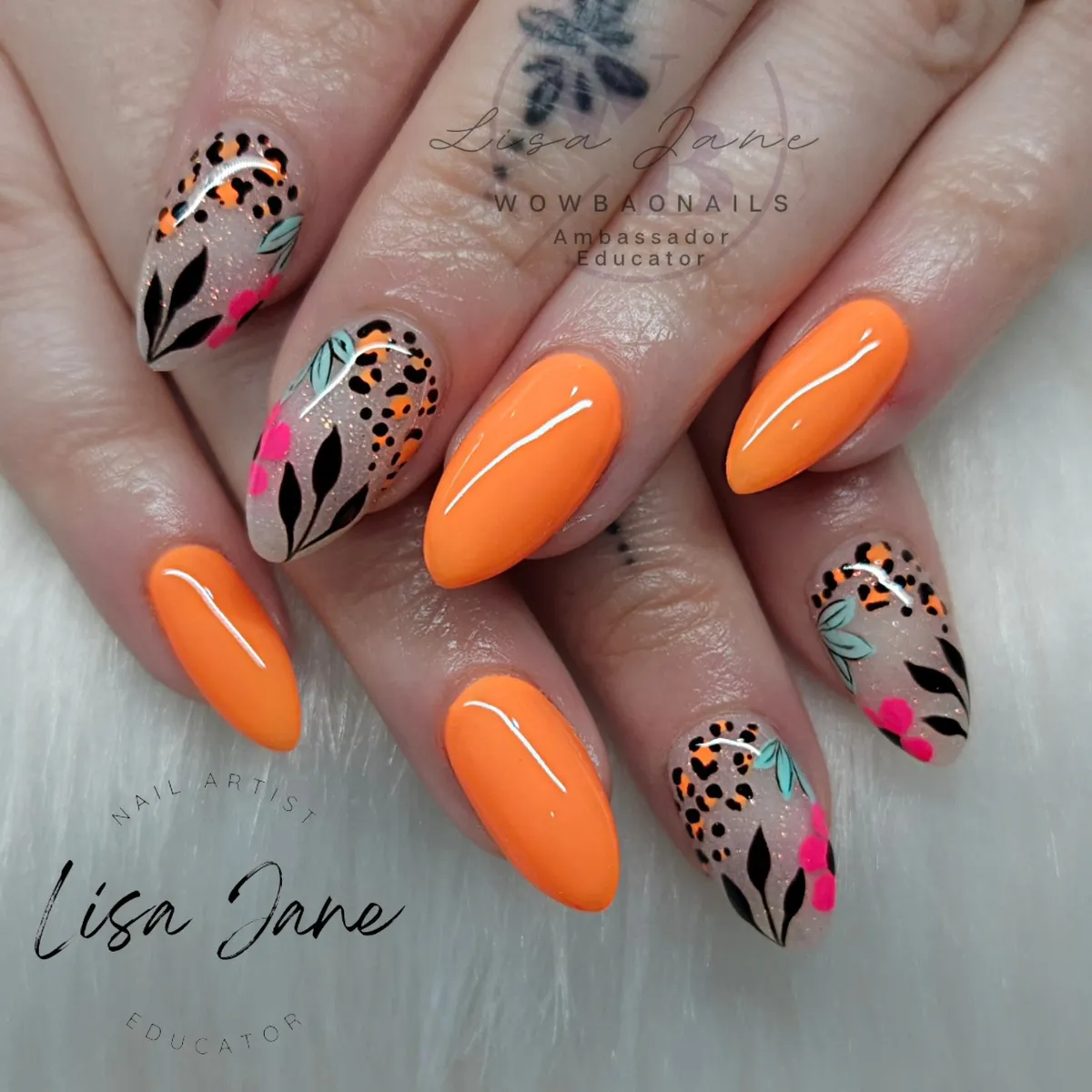 Solid neon orange with botanical and spotted nude accent nails
