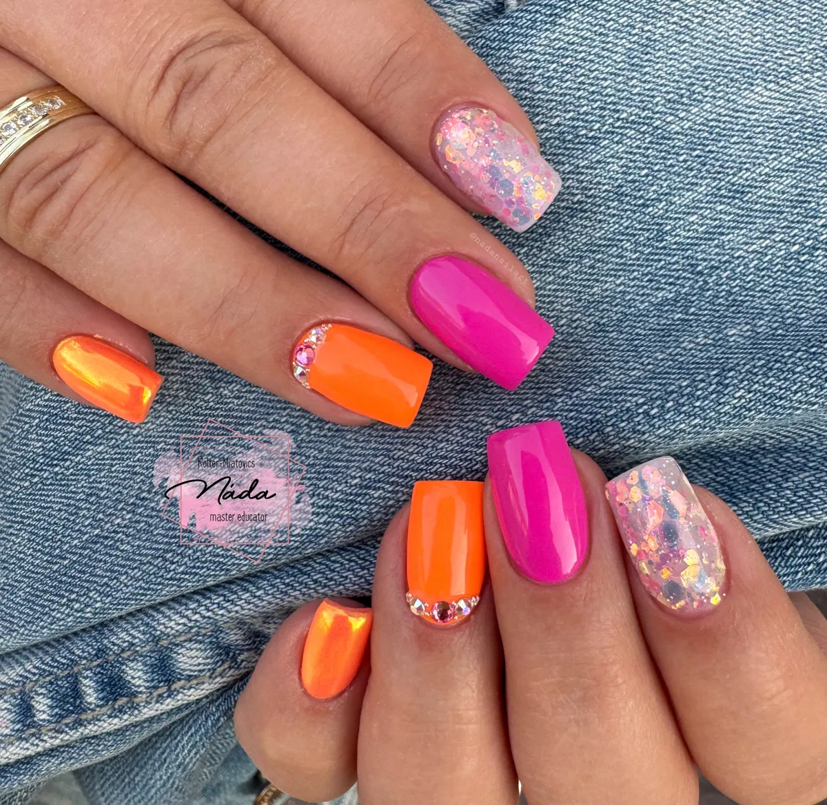Neon orange and hot pink with rhinestone cuticle accents and glitter nails