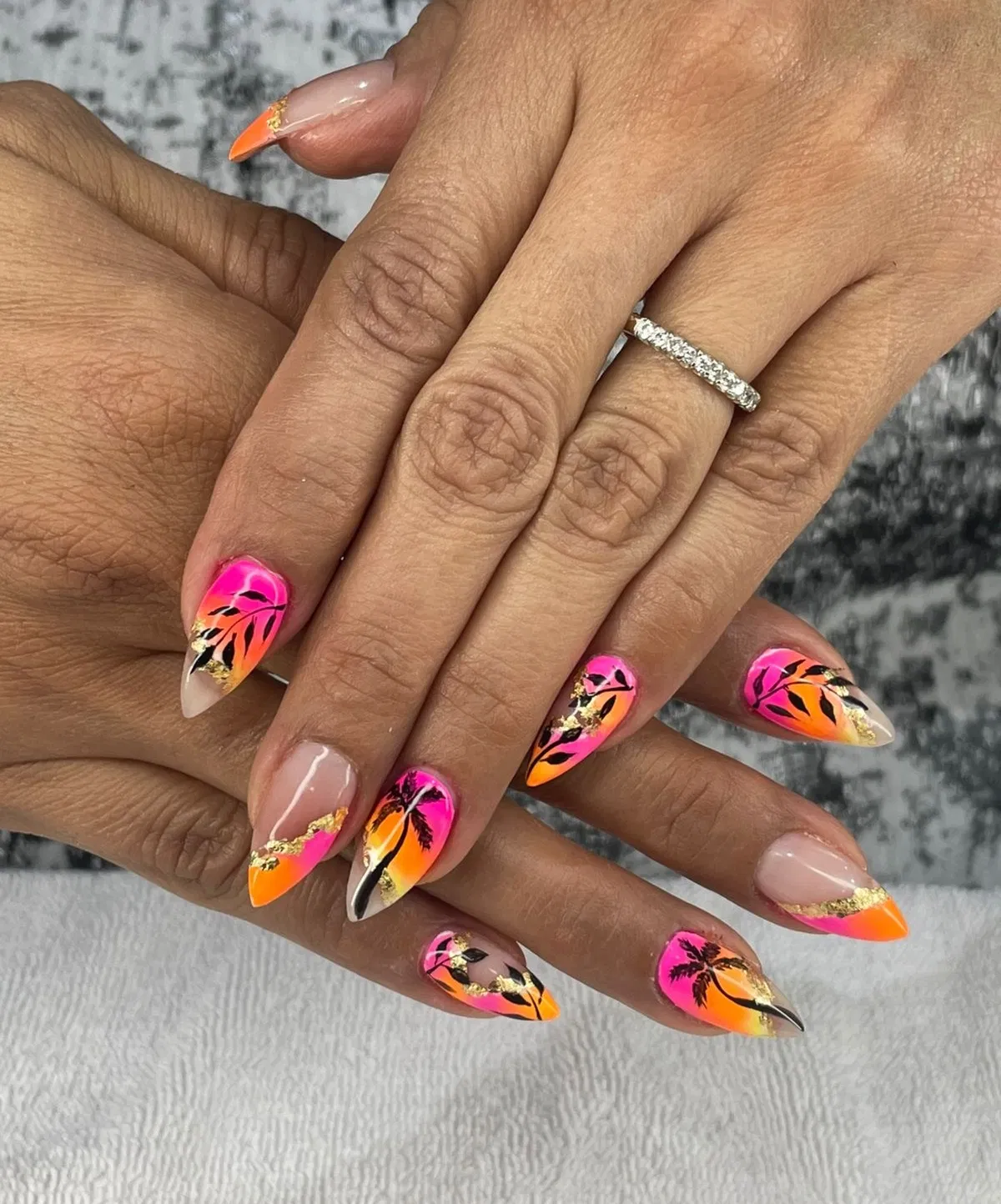 Neon sunset gradients with black palm silhouettes and gold foil accents
