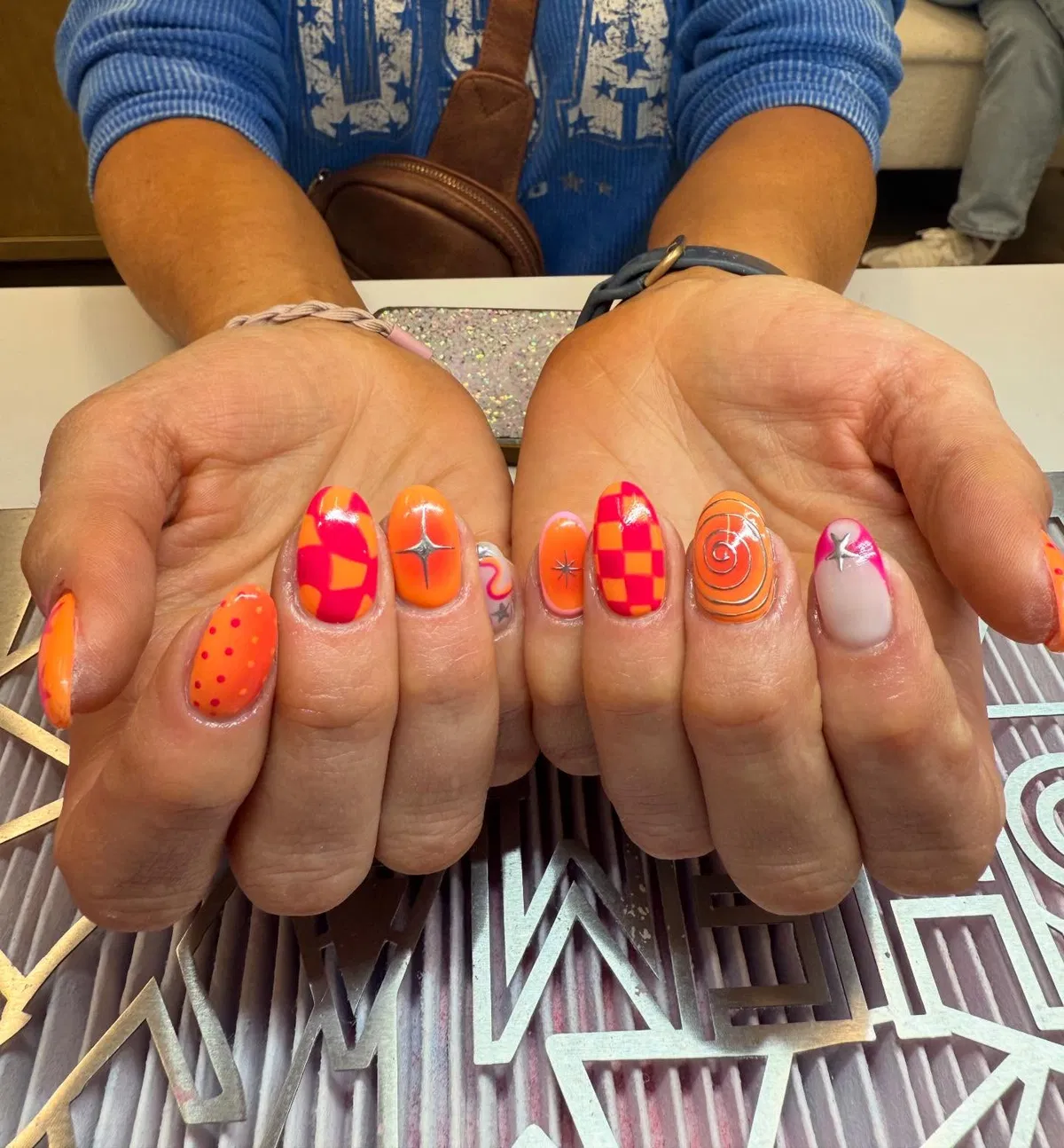 Short orange-pink graphics with checkerboard and star studs