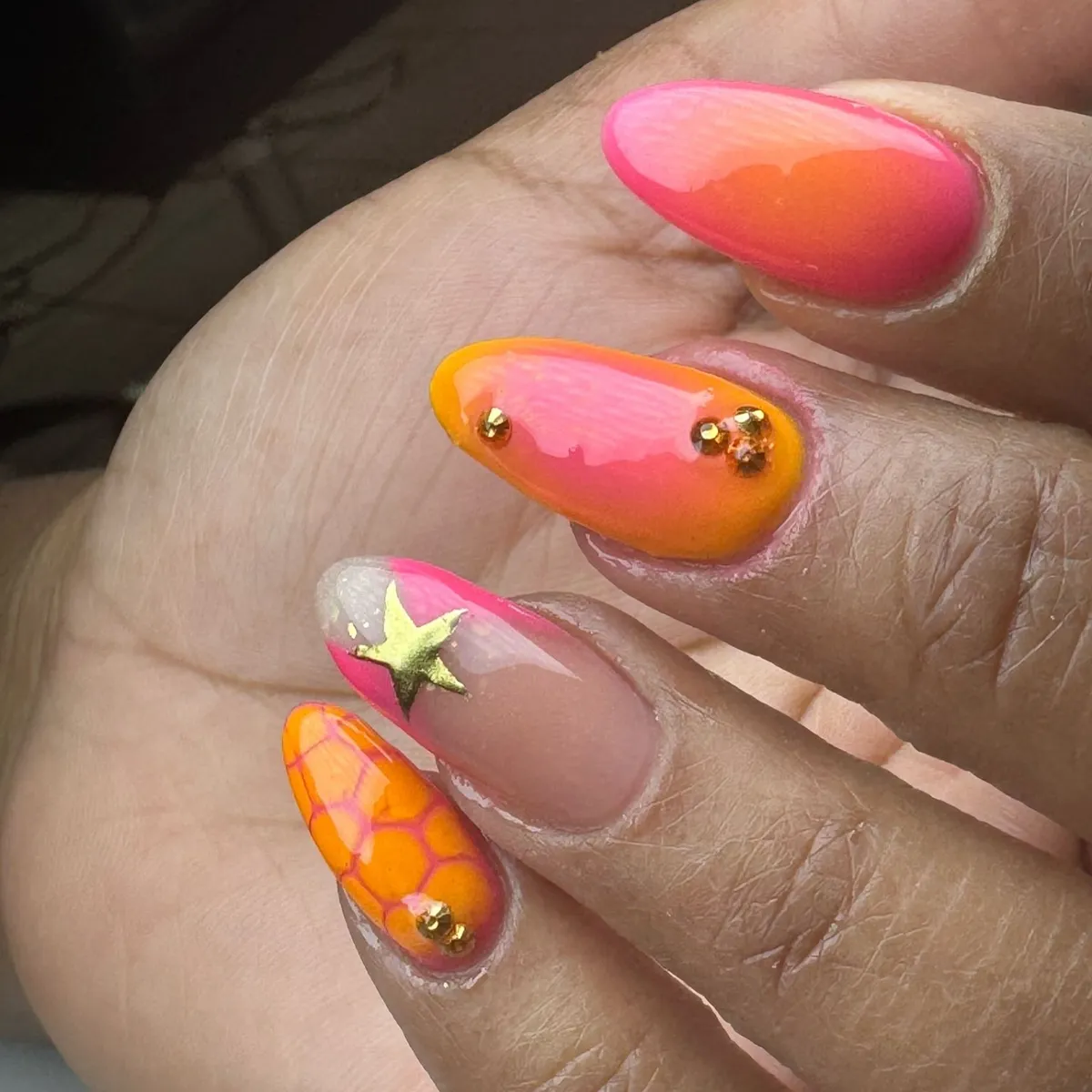 Pink-to-orange ombrΓ© with gold accents and patterned detail