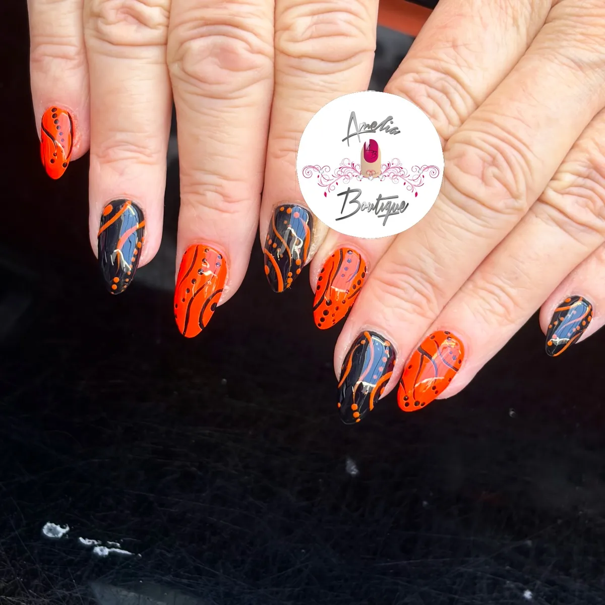Flowing orange-and-black lines with dotted accents