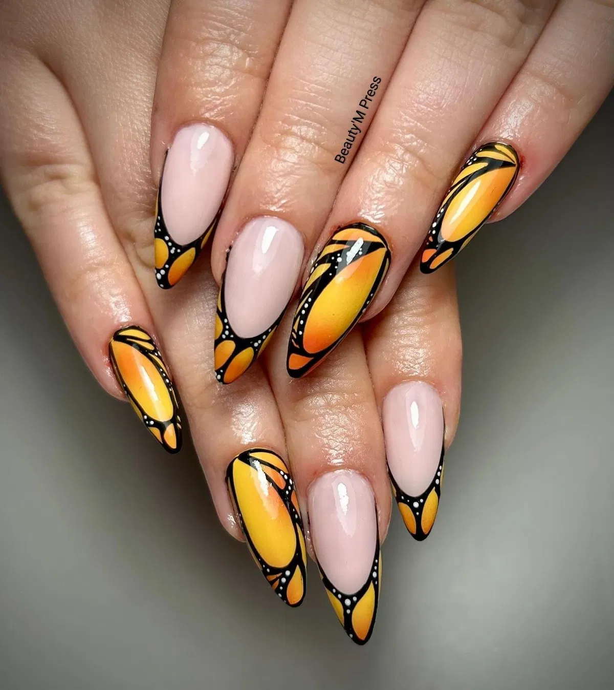 Nude and orange-yellow gradient framed in black with white dots