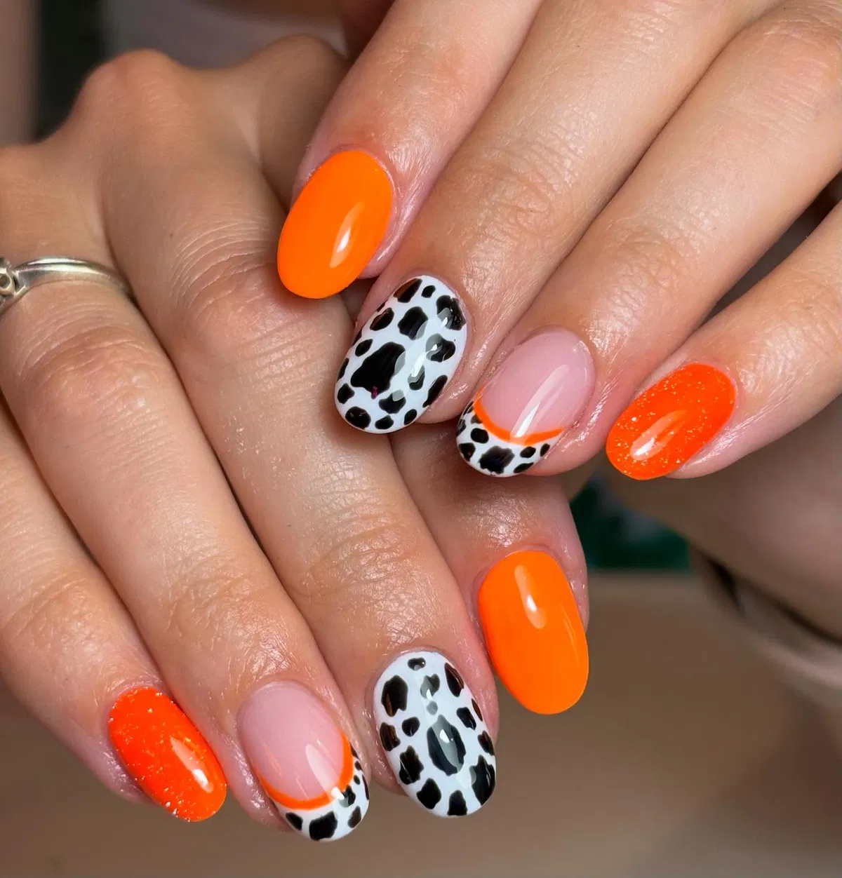 Orange solids with black-spot accent nails