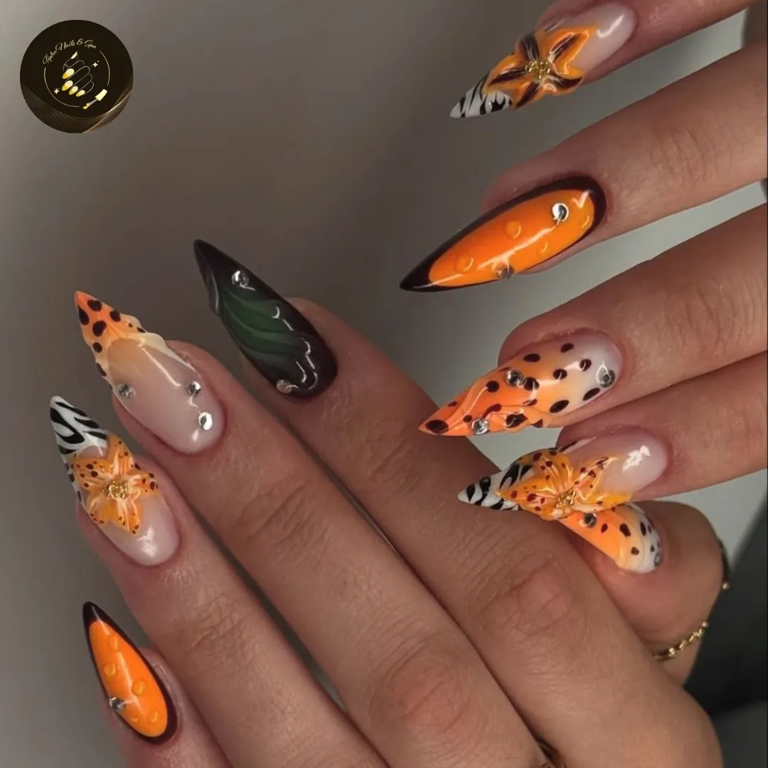 Pointed nails with orange/black tips, stripes, flowers, and studs
