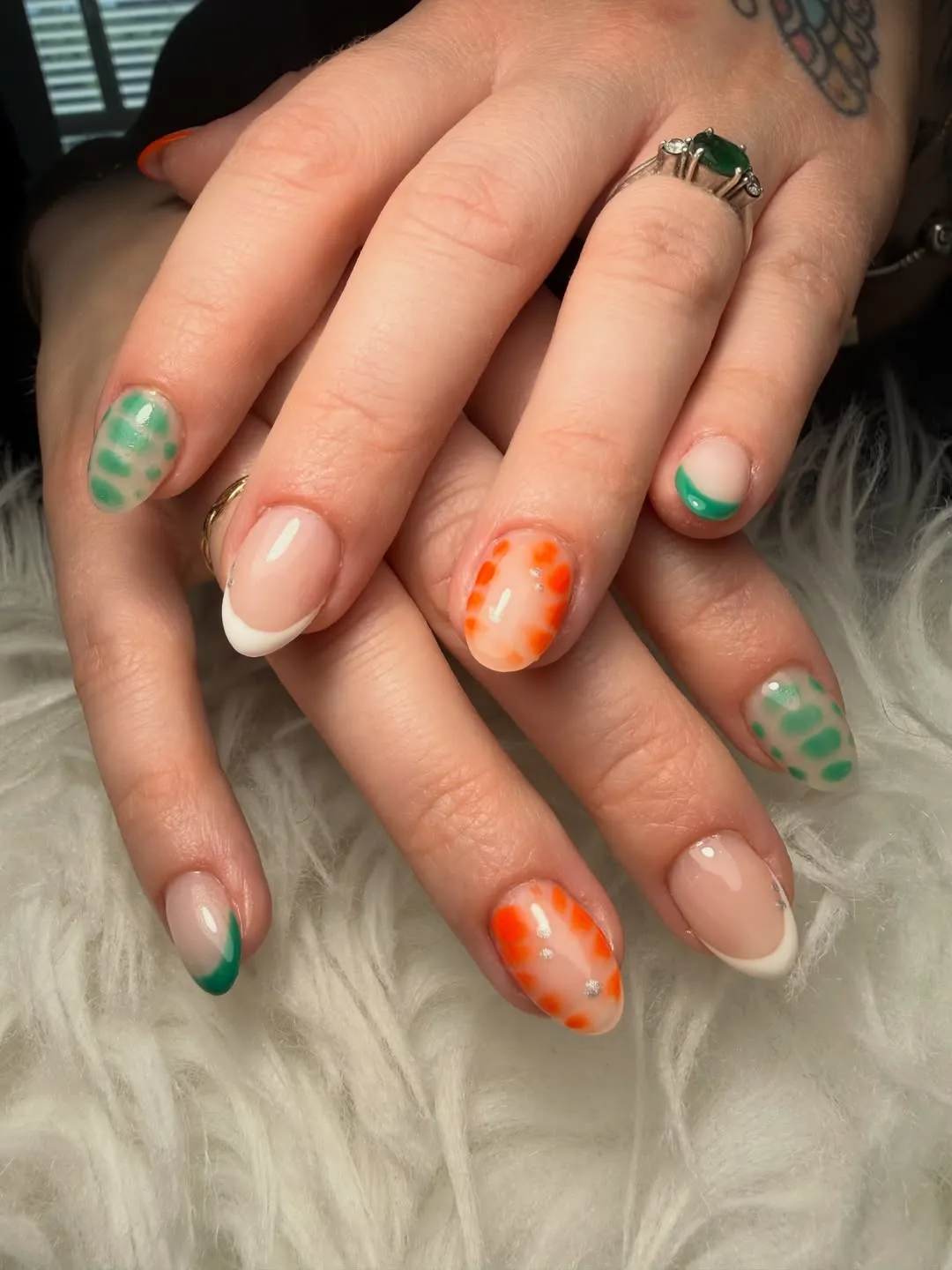 French tips with orange spot accents and rhinestones