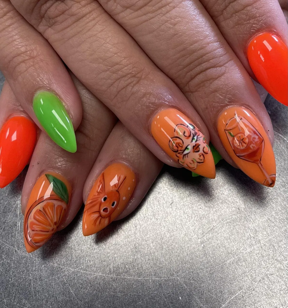 Illustrated orange-themed art with a bright green accent nail