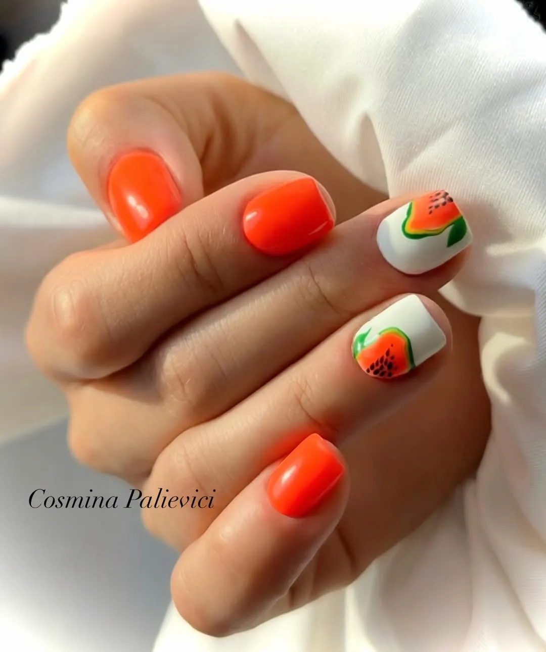 Solid orange with fruit-slice accent nails on white