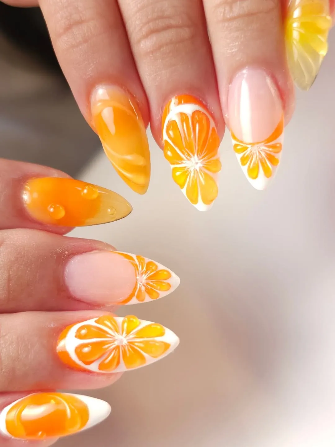 Almond citrus-slice nails in orange and white
