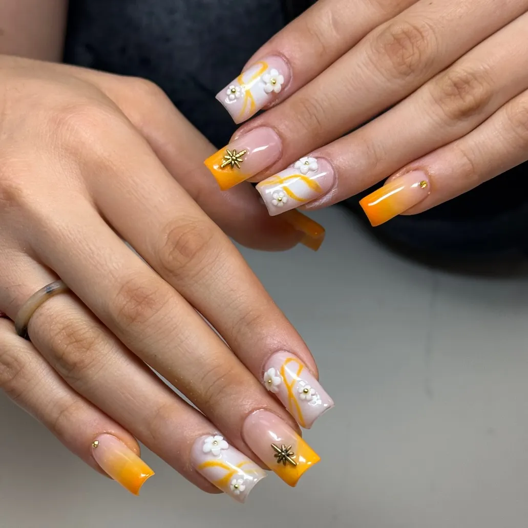 Orange tips with white florals and gold accents