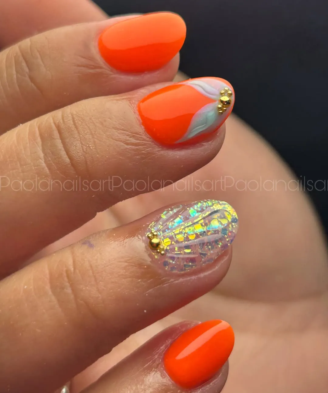 Orange color-blocking with iridescent accent and gold beads