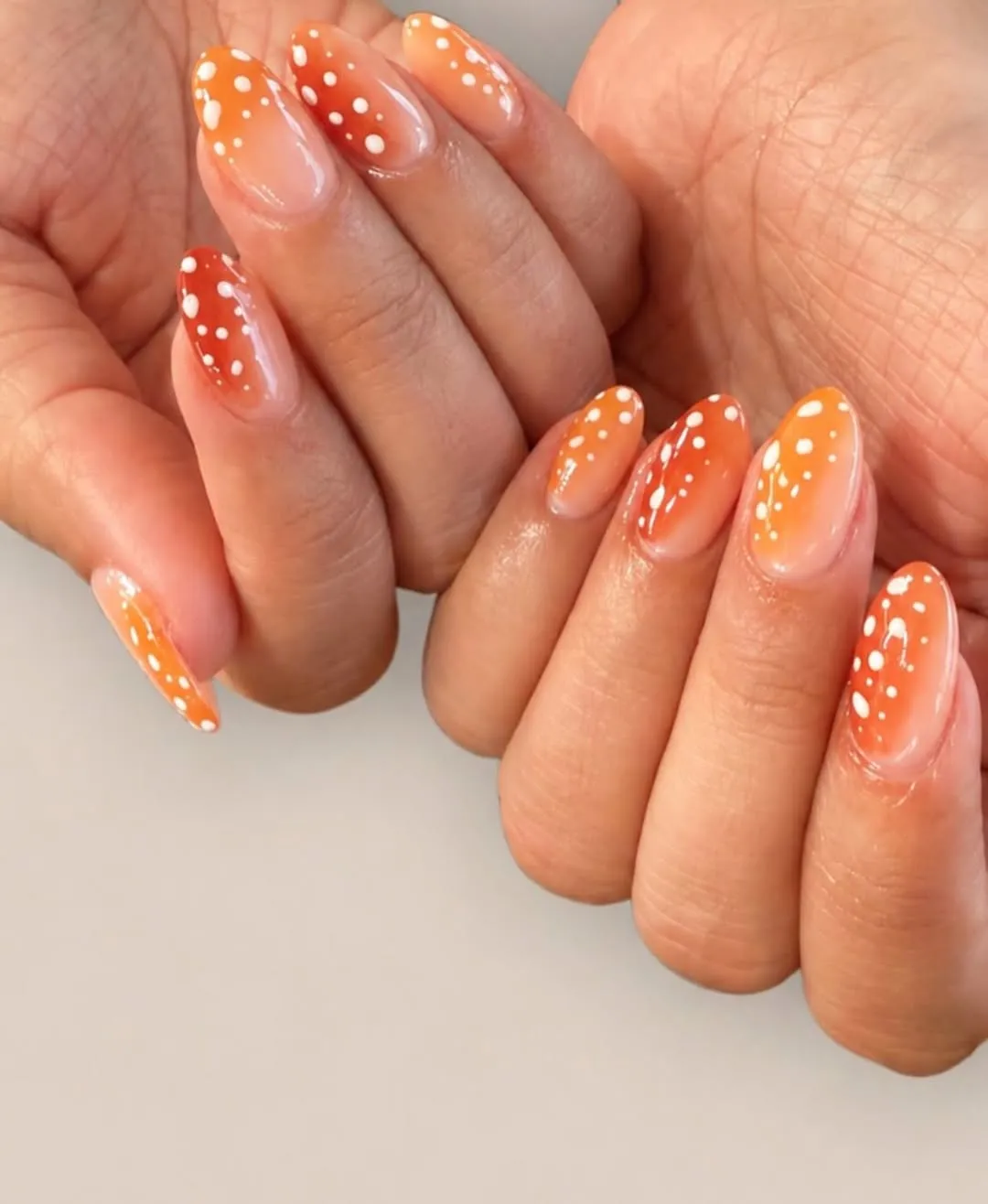 Orange gradient tips with white polka dots