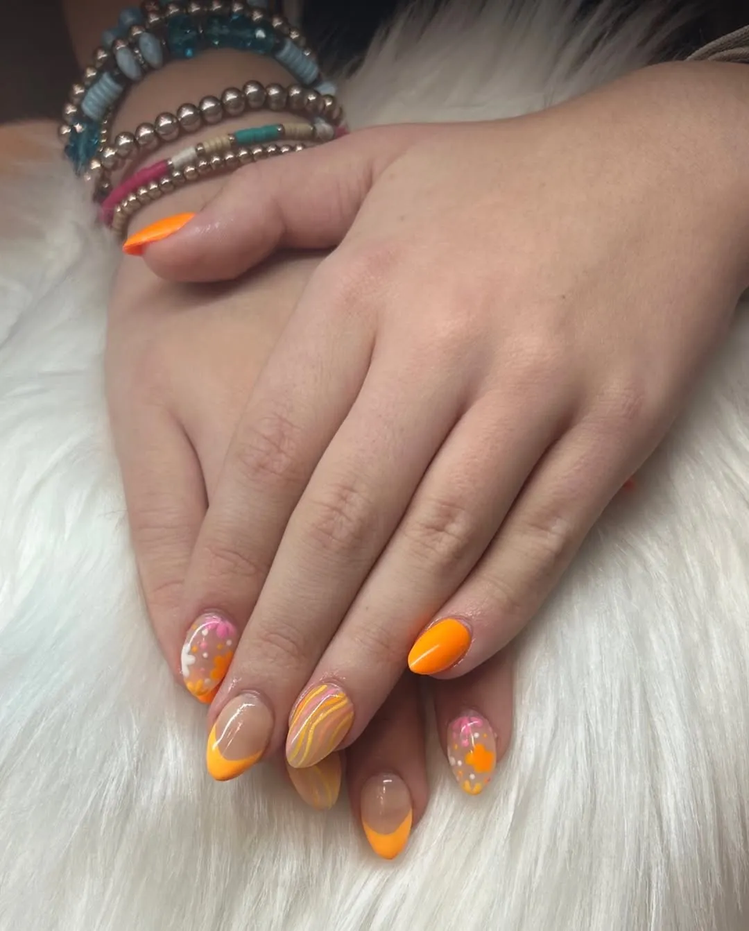 Orange French tips with wavy lines and translucent dotted accents