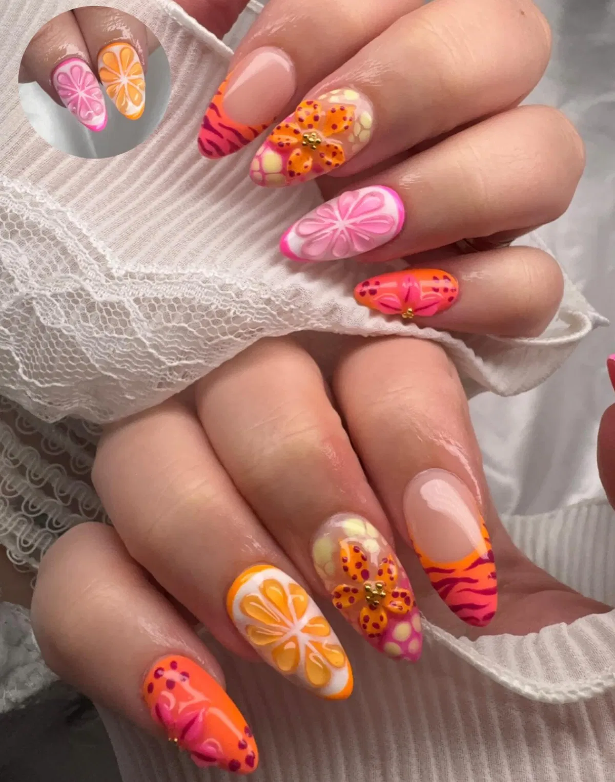 Bright orange and pink mixed nail art with citrus and stripes