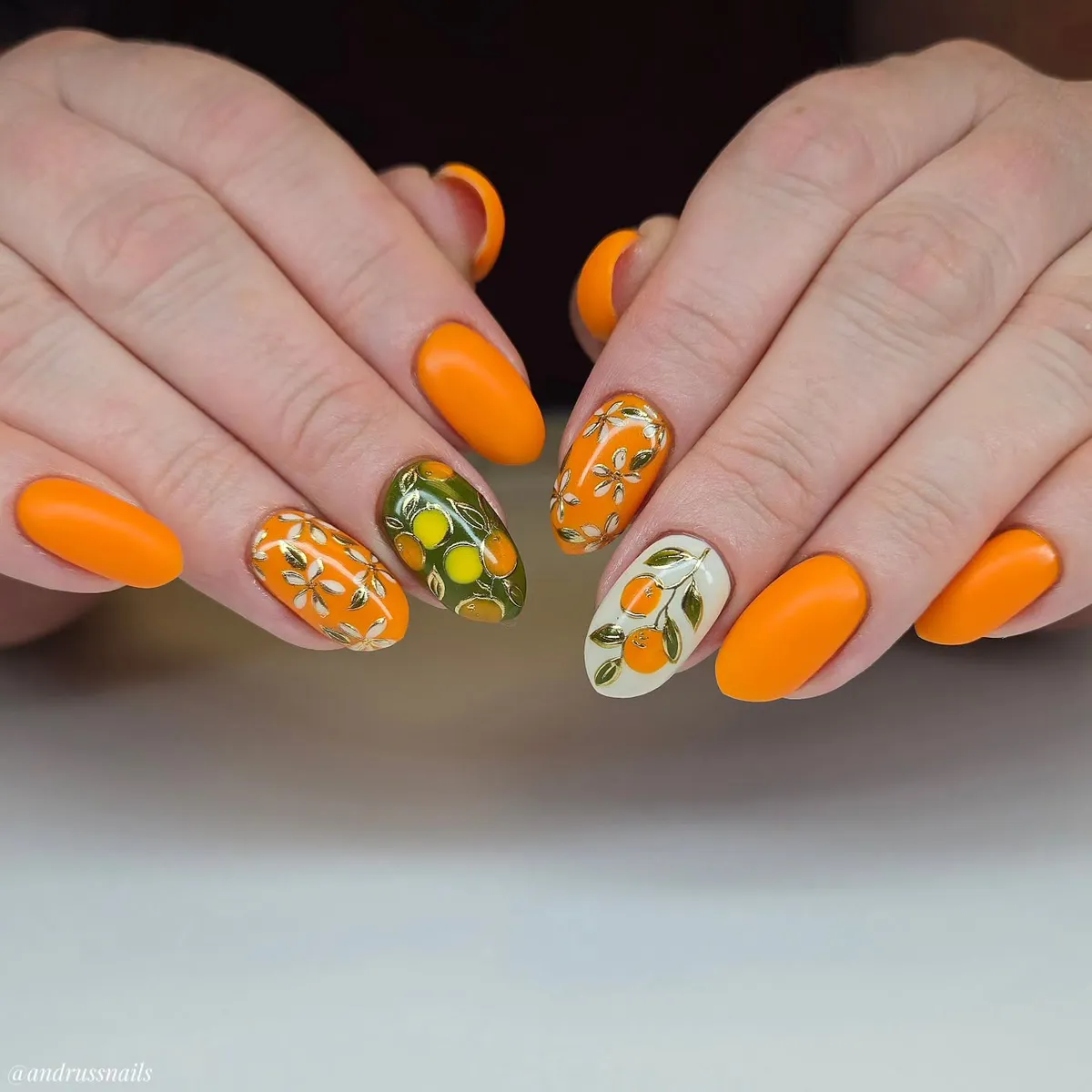 Matte orange set with fruit-and-floral accent nails