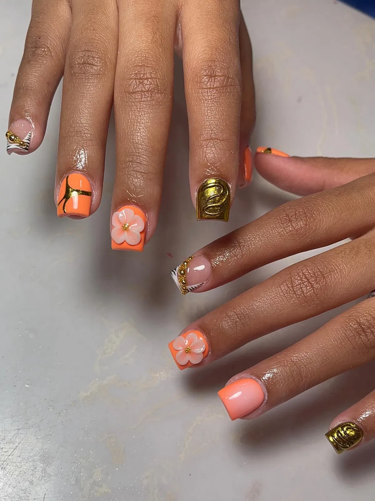 Peach-orange squares with 3D flowers and metallic gold swirls