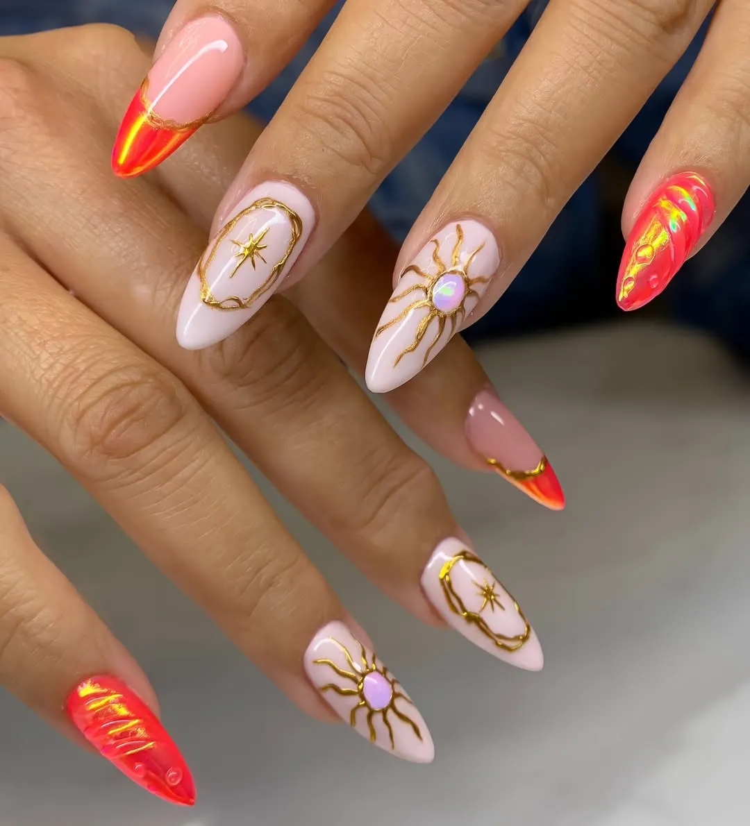 Gold line-art suns with vivid red-orange reflective accents