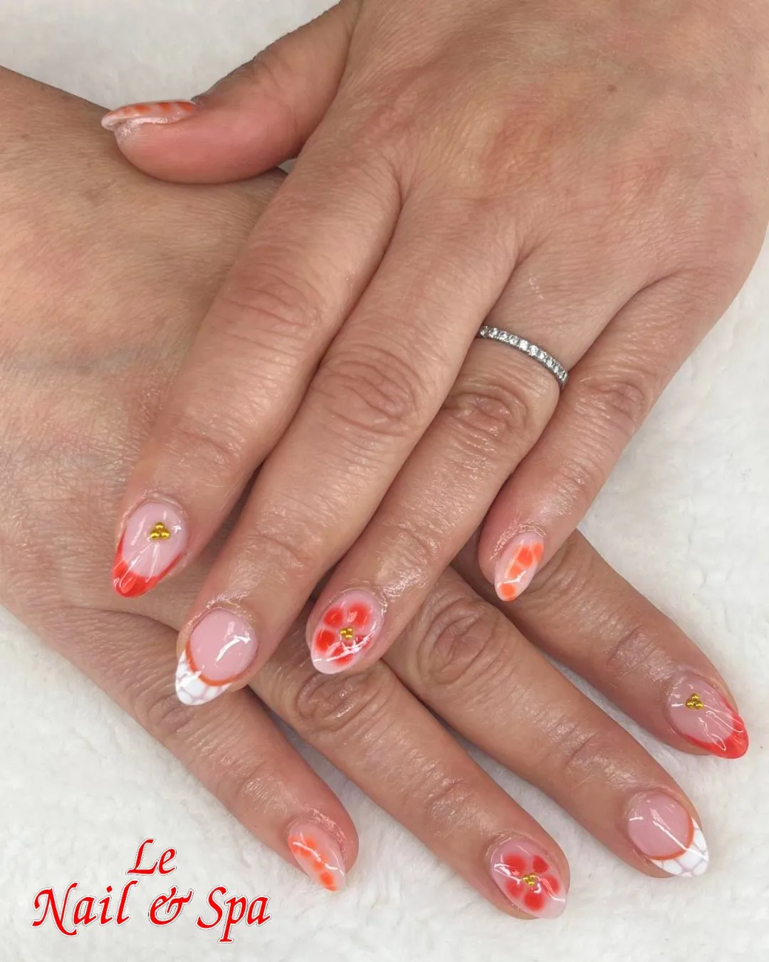 Orange-and-White French Tips with Red-Orange Floral Art