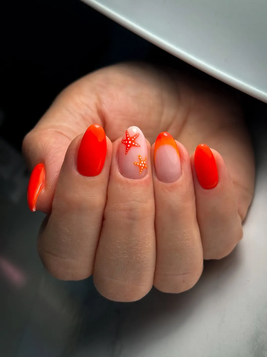 Bright Orange-Red Nails with Starfish Accent and Orange Tip