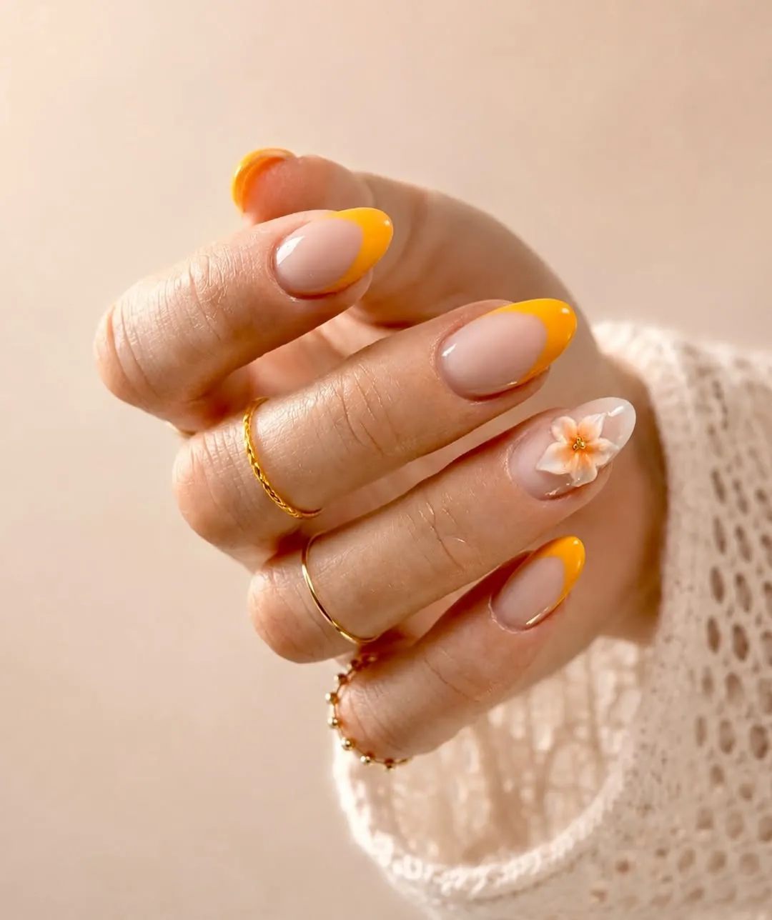 Yellow-orange French tips with a single 3D flower accent