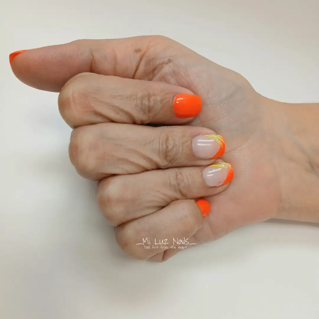 Short orange nails with orange-and-yellow French tips