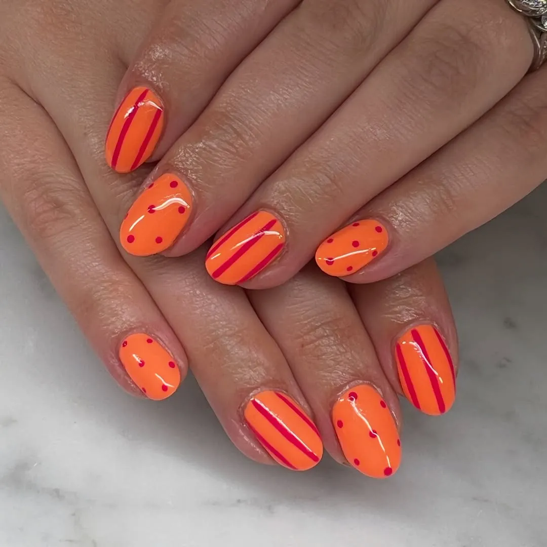 Bright orange with pink stripes and polka dots