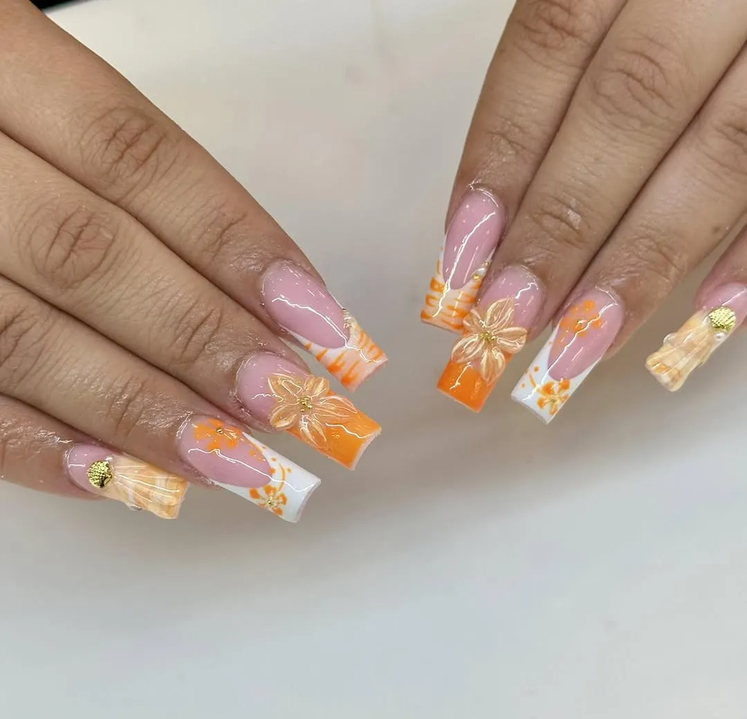 Coffin nails with orange-white tips and floral accents