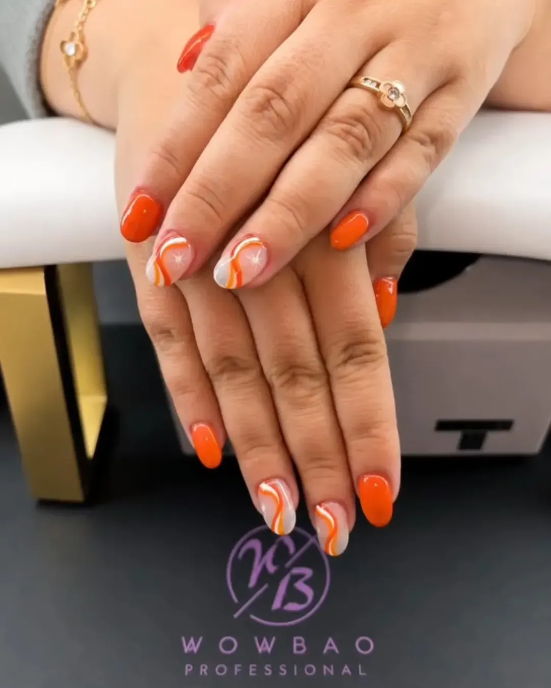 Glossy orange with white-and-orange wavy accent nails