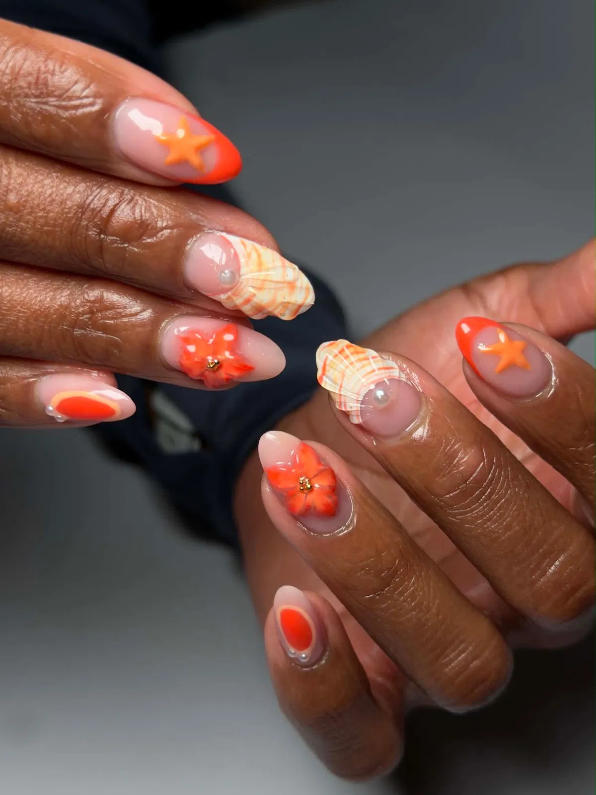 Orange French tips with 3D flowers, starfish, and plaid accents