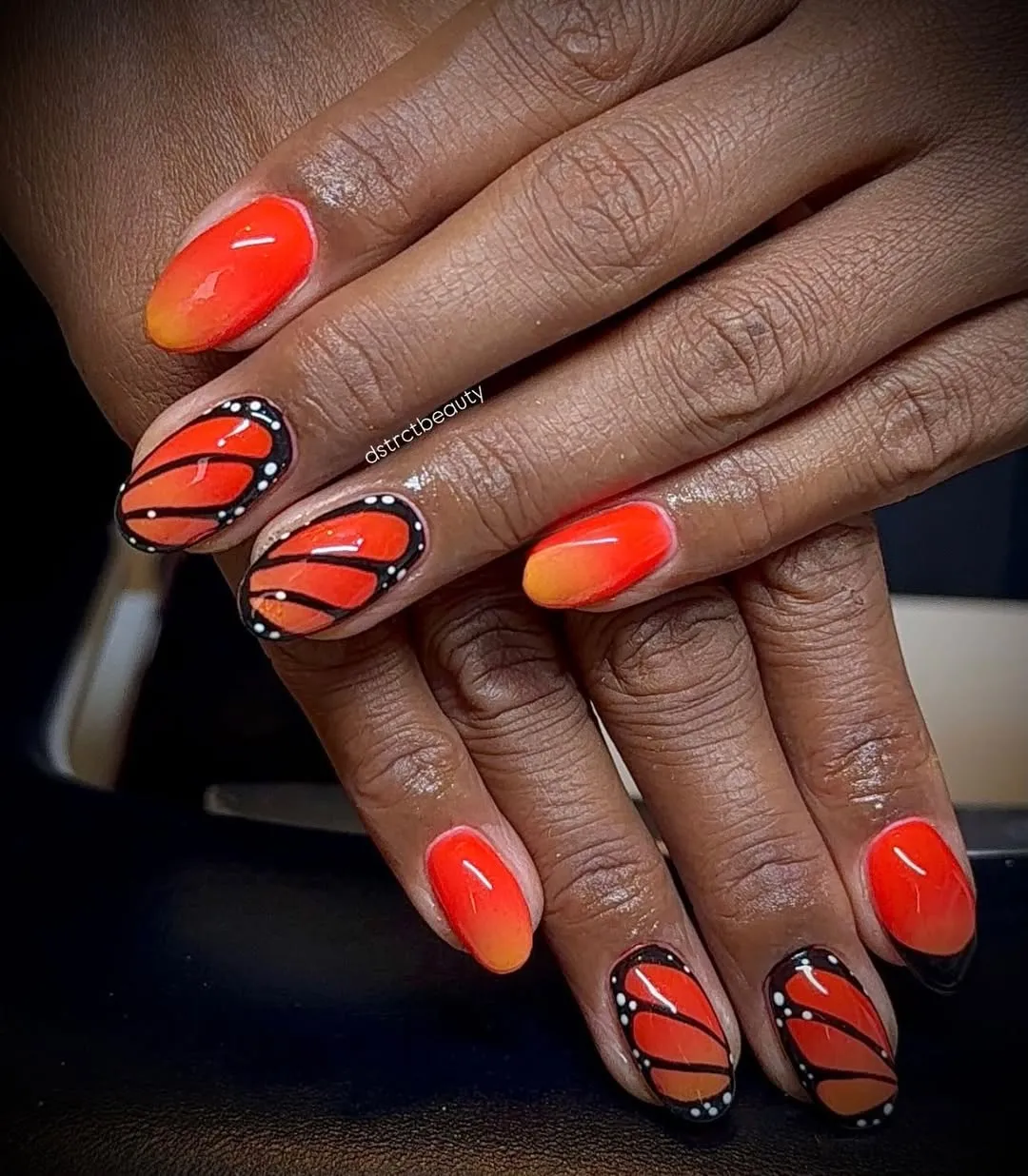 Orange ombre with black-and-white lined accent nails