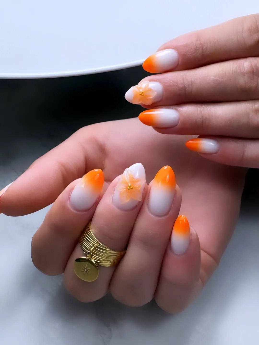 White-to-orange ombre tips with translucent 3D flowers