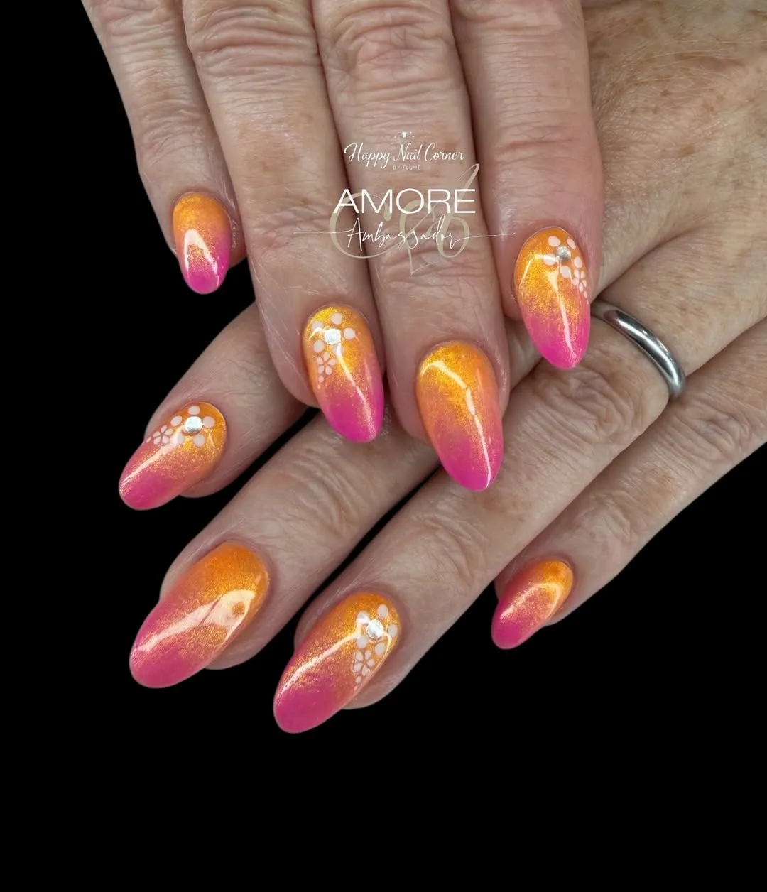 Shimmery orange-to-pink ombre with white dot-flower clusters