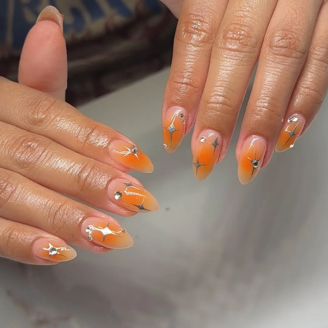 Soft orange ombre with silver starburst accents and studs
