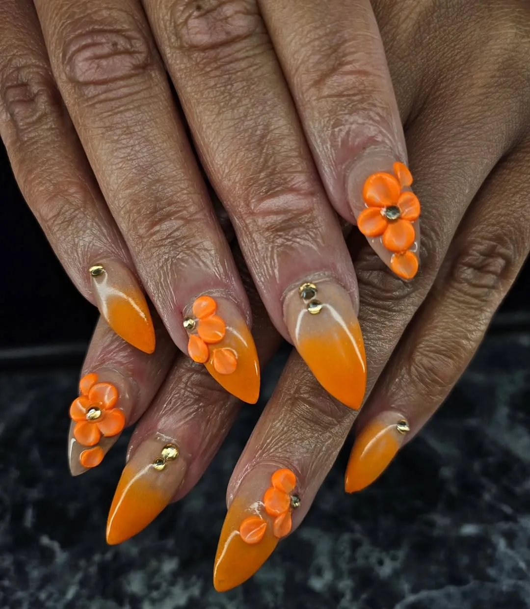 Nude-to-orange ombre with 3D orange flowers and gold studs