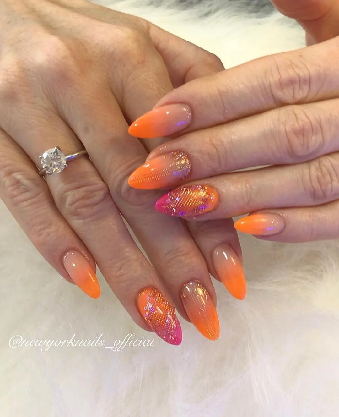 Glossy orange ombre with glitter accent nails