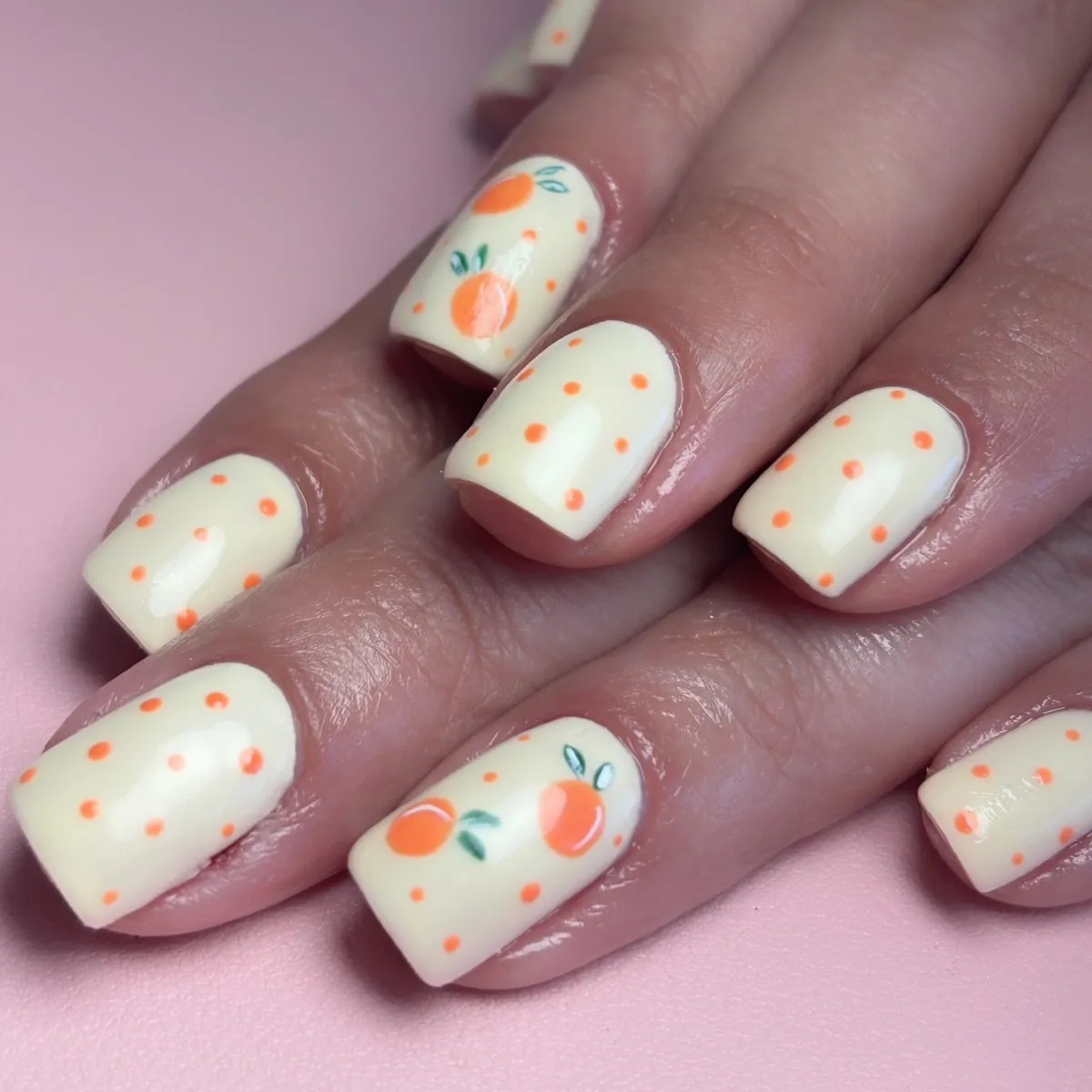 Cream base with orange polka dots and fruit accents