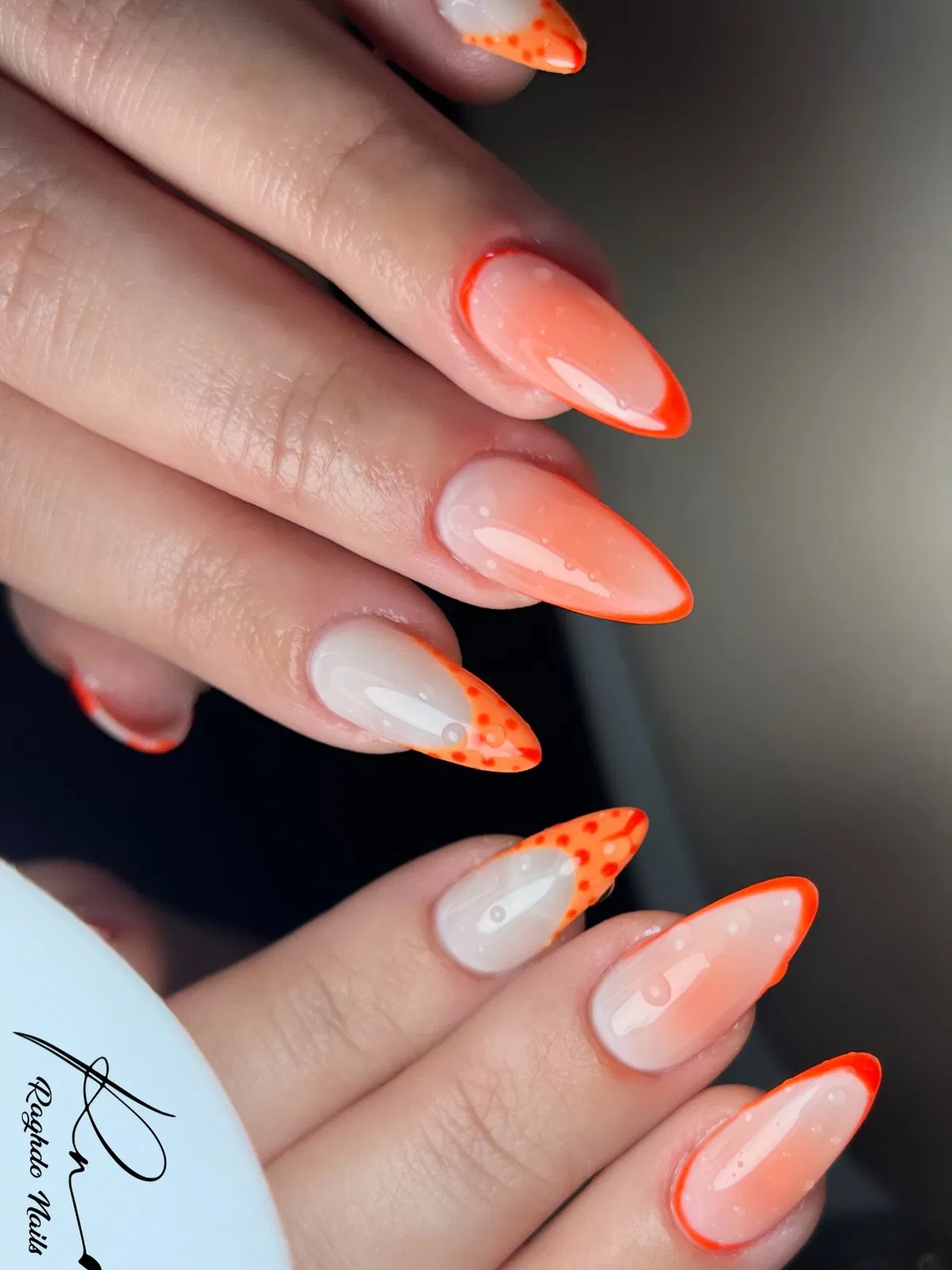 Orange-outlined tips with small orange dot clusters