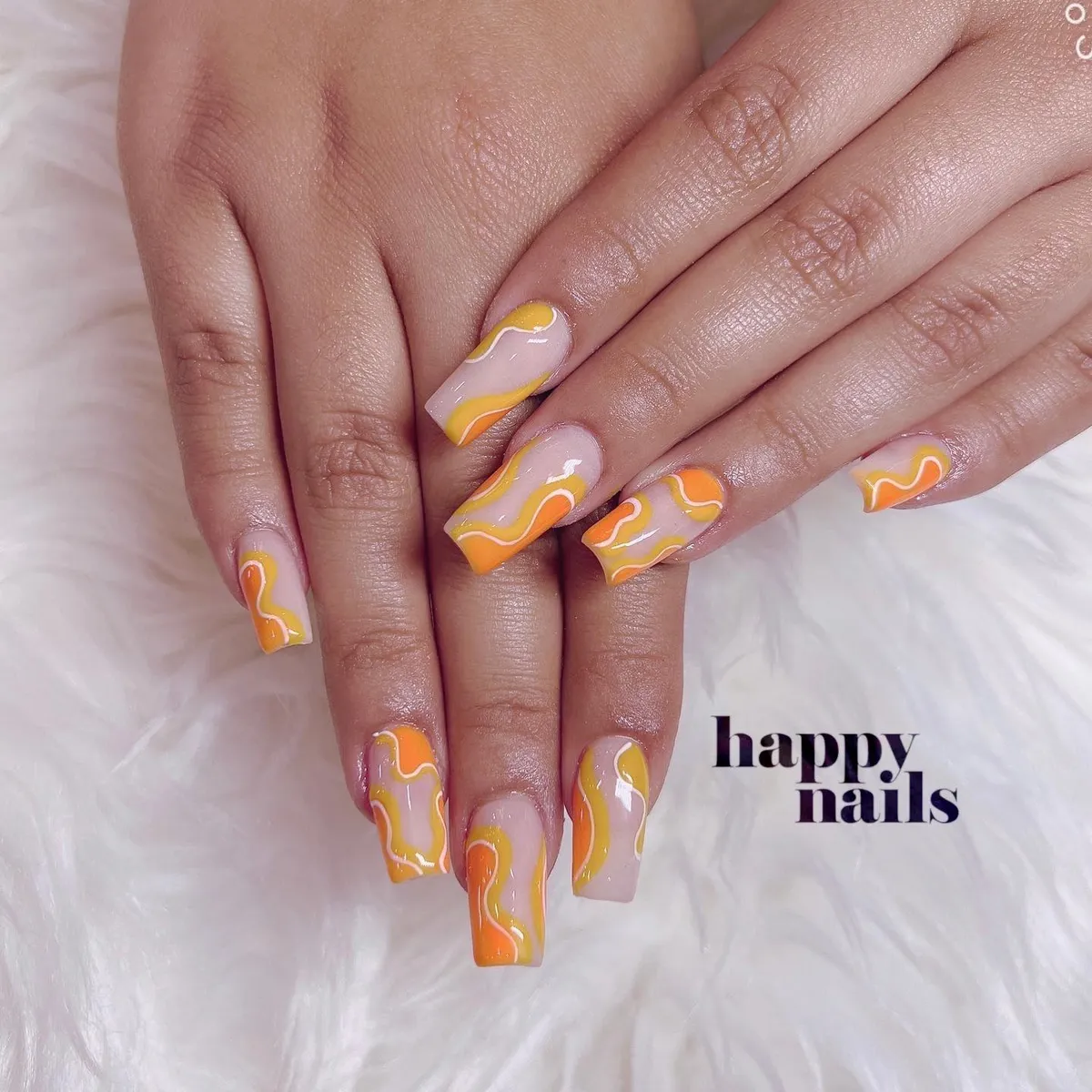 Square nails with pastel orange-yellow-white wavy lines