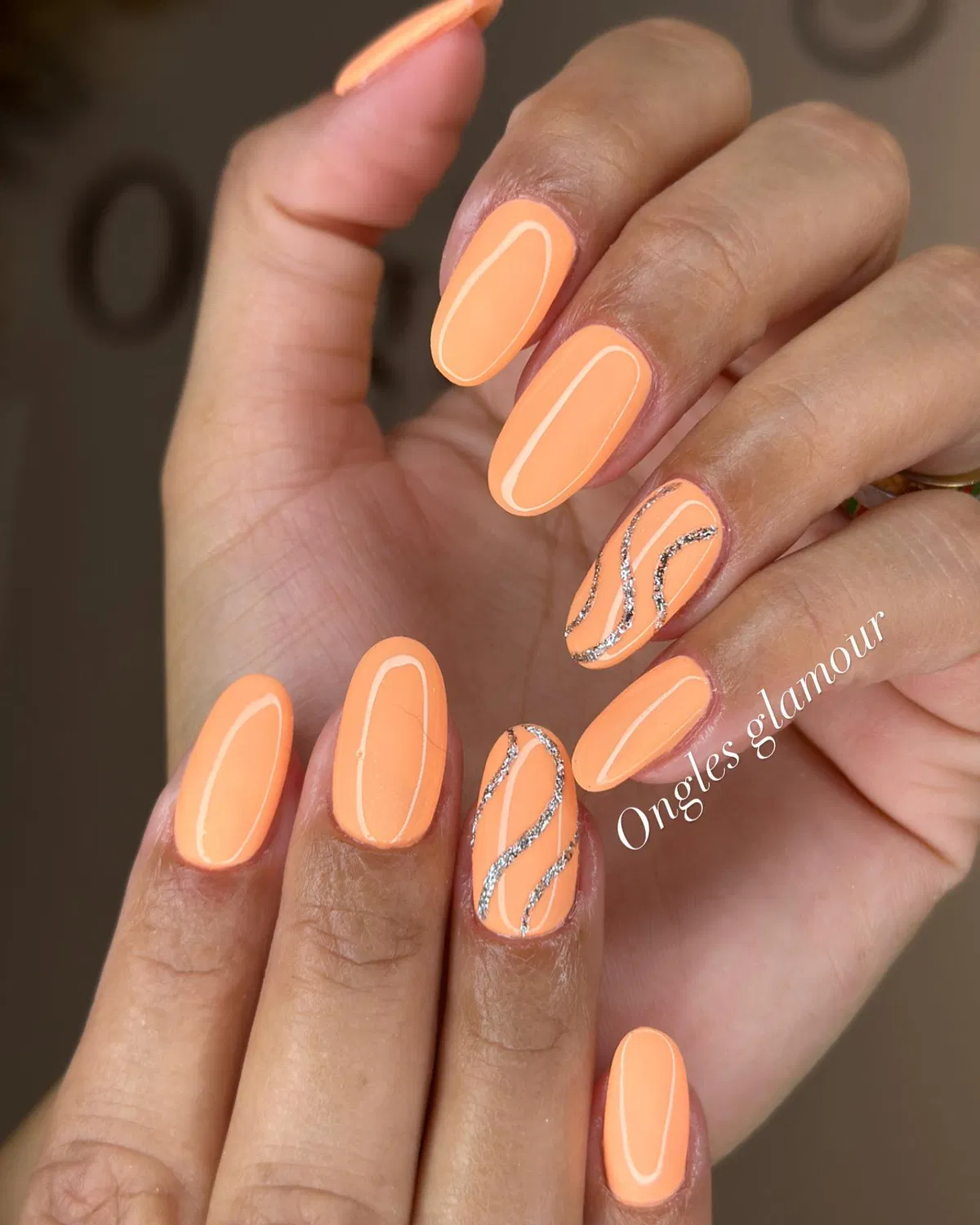 Solid pastel orange with silver glitter wave accents
