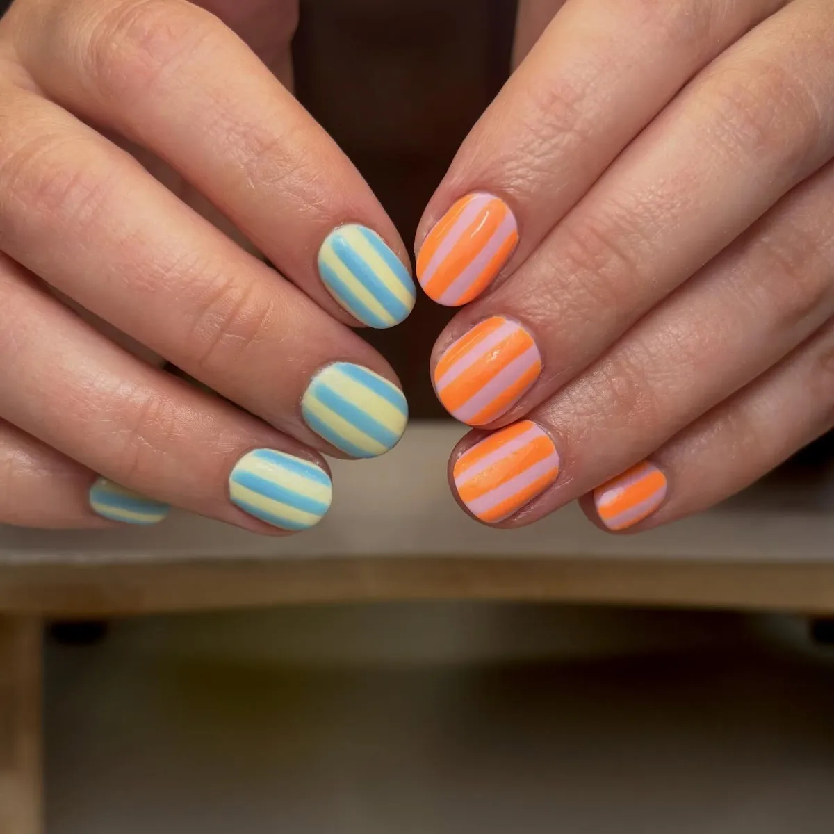 Short striped nails with pastel orange and contrasting pastel sets